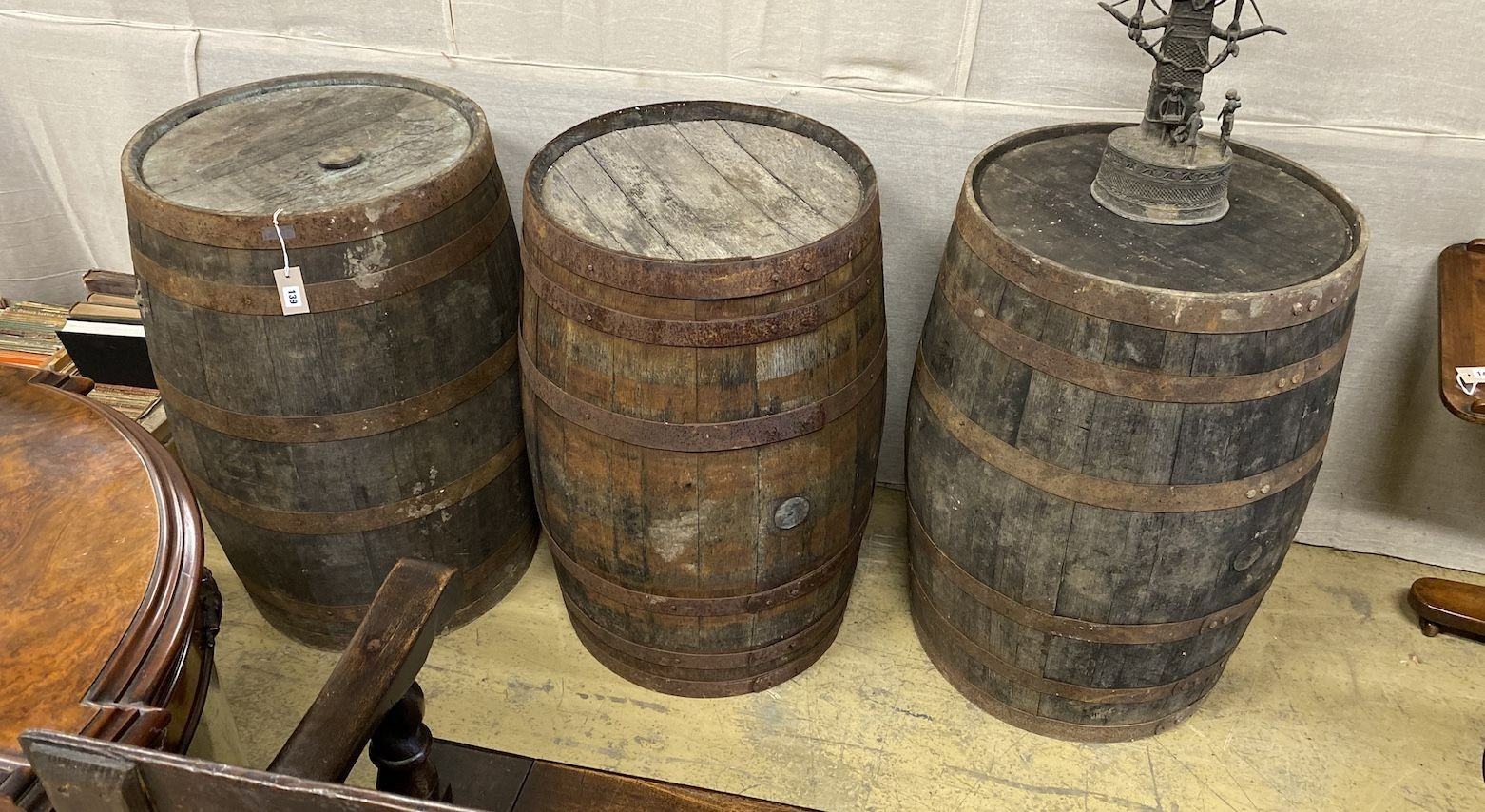 Three vintage staved wood barrels, largest diameter 56cm, height 89cm